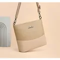 Detail of canvas and leather patchwork bucket bag with adjustable strap and metal logo - Khaki