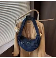 Detail of a dark blue denim crescent crossbody bag with zipper fringe and adjustable strap - One Size / Dark Blue
