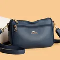 Detail shot of navy blue crossbody bag featuring lychee grain texture and golden logo - One Size / Blue