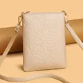 Beige floral embossed leather phone bag with a vertical zip design and gold hardware - Apricot Small Rose