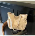 Creamy white nylon tote bag featuring side elastic pockets and dual canvas straps - Off White