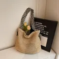 Beige woven straw tote bag featuring a black and white striped fabric shoulder strap - One Size / Khaki with Blue Stripe