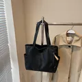 Minimalist black oversized faux leather tote bag with side pockets and pleated texture - One Size / Black