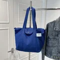 Borsa tote in tela blu brillante con etichetta laterale e tasca frontale a scatto - Taglia unica / Blu