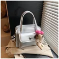 Silver metallic bowling bag with twist lock and cute plush dog charm accessory - Silver