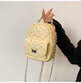 Detail of yellow quilted mini backpack with rhinestone studs and silver chain strap - Yellow
