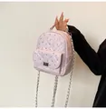Detail of pink quilted mini backpack with rhinestone studs and silver twist lock - Pink
