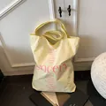 Light yellow canvas tote bag with pink botanical text and large SOCERY logo design - One Size / Yellow