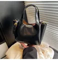 Fashionable black leather bucket bag with top handle and adjustable shoulder strap - With Pendant / Black