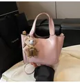 Pink PU leather bucket bag with top handle, crossbody strap and cute teddy bear charm - With Pendant / Pink