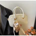 Chic beige crossbody square bag with a plush bear charm and adjustable leather strap - With Pendant / White