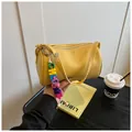 Minimalist yellow cylinder crossbody bag with litchi grain faux leather finish - With Pendant / Yellow
