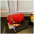 Chic red lychee leather Boston shoulder bag with colorful letter charm and silver zipper - With Pendant / Red