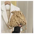Handcrafted beige woven bucket bag with bohemian geometric pattern and tassel drawstring - One Size / Khaki