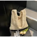 Detail of cream woven crochet bucket bag with hollow mesh texture and cotton lining - One Size / Off White