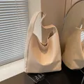 Beige woven hobo bucket bag with wide shoulder strap in premium textured finish - One Size / Apricot