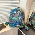 Blue backpack with tropical plant print, front zipper pocket and adjustable straps - Leaf Style
