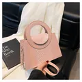 Dettaglio borsa rosa in pelle goffrata coccodrillo con manico tondo e catena dorata - Rosa