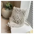 Close-up of bohemian handmade cotton rope macrame bag with tassel fringe and geometric patterns - One Size / Off White