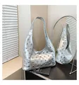 Detail shot of silver metallic hobo bag featuring various sized round punk style rivets - Silver