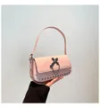 Pink patent leather crossbody bag with metal cross pendant and rivet detailing - Pink