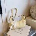 Pale yellow hobo bag with crinkle texture and lace pearl bow charm on a suitcase - No Pendant / Yellow
