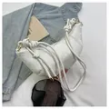 White snakeskin crescent bag with knotted handle and elegant gold hardware details - Off White