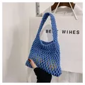 Detail of blue handmade woven mesh bag showing hollow knit pattern with lemons - Blue