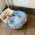Light blue hand-knitted crochet tote bag with colorful 3D flowers and brown leather strap - Blue
