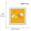 Square enamel Egypt stamp brooch featuring golden pyramids and orange sun on white background - Egypt Pyramid Style (A00761)