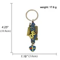 Detail van Zweden souvenir sleutelhanger met blauw-gele letters en gebouwreliëf - Zweden Stijl (B00041) / Brons