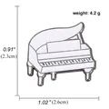 Macro detail of a white enamel piano brooch with silver alloy trim and music stand - Piano Style (A00456)