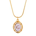 Close-up of gold oval letter G pendant on sleek snake chain with white inlay - Letter G
