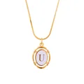 Close-up of gold snake chain necklace with an oval letter U pendant and purple disc - Letter U