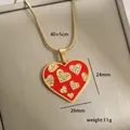 Macro detail of red enamel heart pendant with dimensions 24mm by 26mm on gold chain - Red Enamel Heart Pattern (9-14)