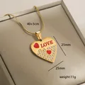 Detailed view of 14k gold heart necklace with LOVE engraving and crystal accents - Love Text Red Heart (9-15)