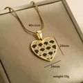 Macro detail of gold-plated heart pendant with black enamel fish scale pattern and crystals - Scale Pattern Black Enamel (9-17)