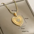 Macro view of 14k gold heart pendant with sunburst texture and sparkling rhinestones - Radial Sun Pattern (9-18)