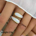 Detailed view of golden tassel open ring with white enamel inlay and 7.2mm width detail - Marbled Open Ring (232) / 7.2mm
