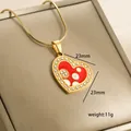 Macro detail of 14k gold heart pendant with red enamel, measuring 23mm and weighing 11g - Red and White Heart Overlap (10-2)