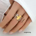 Detail view of gold and silver flower petal ring with 15.4mm diameter size on model hand - Triple Leaf Design (253)