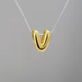Detailed close-up of 3D gold balloon letter V pendant with a high-polished mirror finish - Letter V