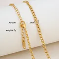 Macro detail of 18K gold plated stainless steel curb chain with lobster clasp and tag - Classic Curb Chain Style / Gold