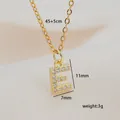 Macro detail of gold letter E pendant necklace with cubic zirconia and dimensions - Letter E
