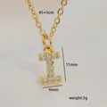 Close-up of gold letter I pendant with sparkling cubic zirconia on a silk background - Letter I