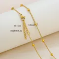Detail of 18K gold-plated beaded chain necklace with lobster clasp and size labels - Polished Beaded Chain Style / Gold