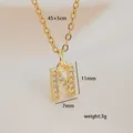 Close-up of golden letter N pendant necklace with micro-paved cubic zirconia crystals - Letter N