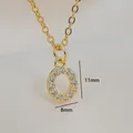 Macro shot of gold zircon letter pendant measuring 11mm in height and 8mm in width - Letter O