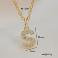 Detailed view of a gold zircon-studded letter S necklace with dimensions and weight - S