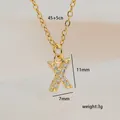 Detailed view of gold letter X pendant with cubic zirconia, size 11mm by 7mm - Letter X